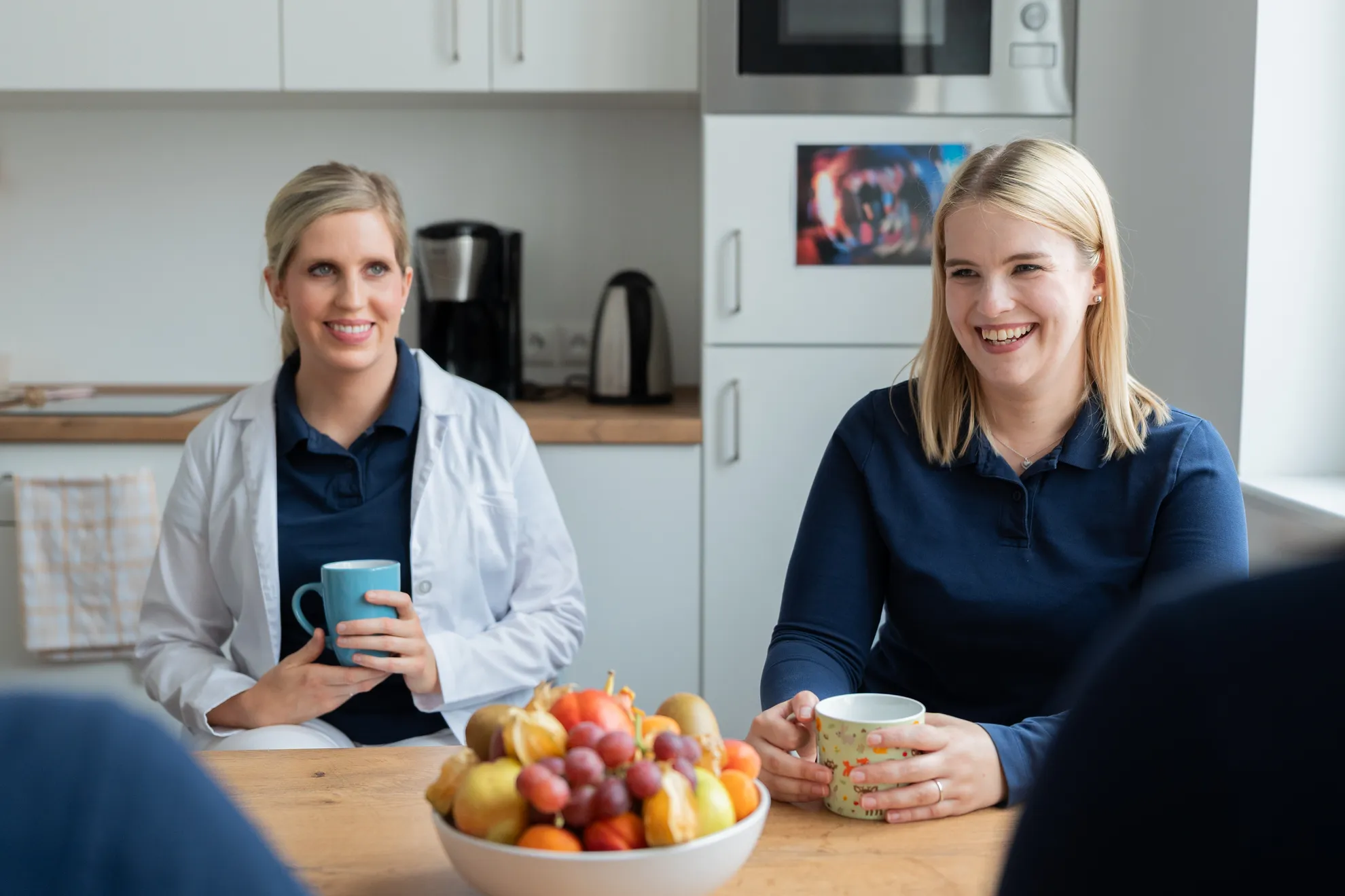 Team sitzt um Tisch mit frischem Obst